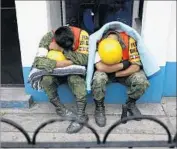  ??  ?? SOLDIERS take a nap after assisting in search and rescue efforts. Mexican President Enrique Peña Nieto toured some of the worst-hit parts of the capital.