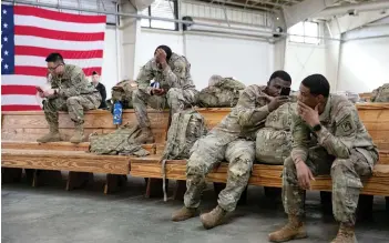  ?? Photo — AFP ?? US service members wait at the Pope Army Airfield before deploying to Europe at Fort Bragg, North Carolina.