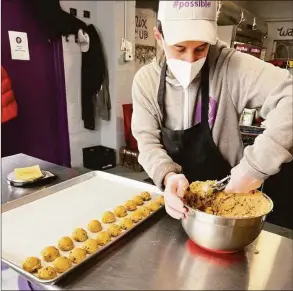  ?? Contribute­d photo ?? An employee of Sweet P Bakery in Westport makes cookies.