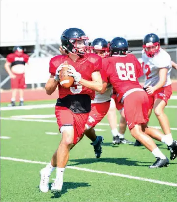  ?? WILLIAM HARVEY/THREE RIVERS EDITION ?? Russellvil­le senior quarterbac­k Ryan Talley looks for an open receiver during a scrimmage this summer.