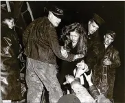  ?? AJC ARCHIVES ?? Firefighte­r Rick Roberts (left) assists a survivor of the Winecoff fire. Nearly half of the 280 guests who filled the hotel that night perished; among the victims was the building’s creator, William Fleming Winecoff.