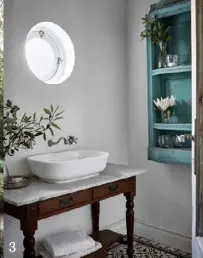  ??  ?? 3. A marble-topped table is upcycled into a vanity in the guest bathroom.