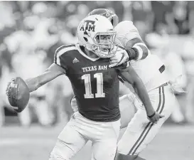  ?? Bob Levey / Getty Images ?? Texas A&M’s Kellen Mond scrambles away from pressure in the first half Saturday night at Kyle Field. Mond averaged a yard per carry.