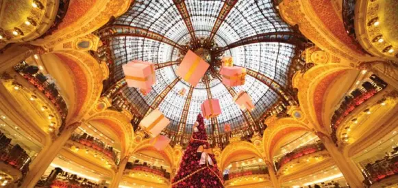  ?? DREAMSTIME ?? The Galeries Lafayette department store in Paris is ablaze with light at Christmas. The holidays are a fabulous time of year to visit one of the world’s great cities.