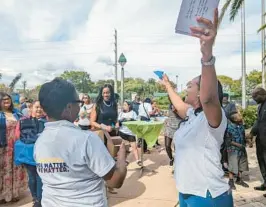  ?? BRITTANY WALLMAN/SOUTH FLORIDA SUN SENTINEL ?? Broward County Human Traffickin­g Coalition President Jumorrow Johnson, right, leads a live release of butterflie­s Saturday. Johnson led Saturday’s town hall meeting on traffickin­g.