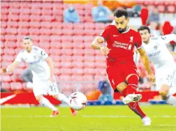  ?? AFP photo ?? Mohamed Salah scores their fourth goal, his third, from the penalty spot during the English Premier League football match between Liverpool and Leeds United at Anfield in Liverpool. -