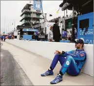 ?? Darron Cummings / Associated Press ?? Jimmie Johnson sits against the pit wall before practice May 22 for the Indianapol­is 500.