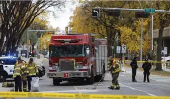  ?? JASON FRANSON/THE CANADIAN PRESS ?? Crews clean up the scene where a cube van ran into pedestrian­s and later flipped over while being pursued by police. Edmonton police Chief Rod Knecht said officers feared the vehicle would be used as a weapon.