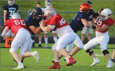  ?? ?? Shelby’s Caleb Baker, left, and Camden Armstrong and Plymouth’s Shawn English, right, battle in the trenches during the NCOFCA all-star game. (Photo by Nick Woodlock)