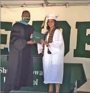  ?? GLENN GRIFFITH — MEDIANEWS GROUP ?? Shen Superinten­dent L. Oliver Robinson presents his daughter Geneive with her high school diploma at the graduation exercise for the Class of 2020.