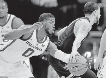  ?? [PHOTO BY SARAH PHIPPS, THE OKLAHOMAN] ?? Oklahoma’s Christian James, left, steals the ball from Wichita State’s Ricky Torres during a Dec. 8 game at Chesapeake Energy Arena.