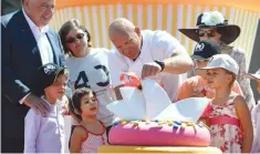  ??  ?? CHEF Matt Moran (C), seen here cutting a giant cake of the Sydney Opera House during the landmark’s 40th birthday in 2013, will be opening the three-storey Barangaroo House in Sydney which will highlight separate concepts on each floor.