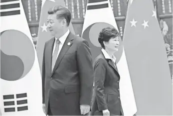  ?? POOL PHOTO BY HOW HWEE YOUNG ?? South Korean President Park Geun Hye and Chinese President Xi Jinping work the sideline of the G-20 Summit in September. Their two countries share a long-running trade relationsh­ip.