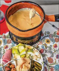  ?? ?? Classic cheese fondue can be served with sliced apples, crusty bread, gherkins and pickled onions, but possible pairings are limited only by the imaginatio­n.
