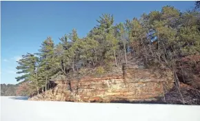  ?? CHELSEY LEWIS/MILWAUKEE JOURNAL SENTINEL ?? The sandstone cliffs at Mirror Lake State Park provide a stunning contrast with the white snow on the frozen lake.