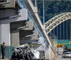  ?? Michael M. Santiago/Post-Gazette ?? Emergency personnel investigat­e the scene of a fatal single-vehicle car crash on June 13 on Beaver Avenue in Manchester.