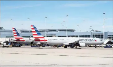  ?? RHONA WISE/AFP ?? American Airlines planes sit at the gate on the tarmac of McCarran Internatio­nal Airport in Las Vegas, Nevada, on February 15, 2017.