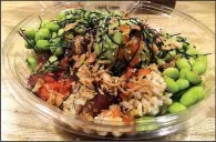  ?? Arkansas Democrat-Gazette/ERIC E. HARRISON ?? A build-your-own poke bowl at Poke Hula, with brown rice, marinated tuna, shrimp, double edamame, masago, ponzu and Hula sauces, sesame seeds, dry seaweed and crispy onion.