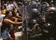  ?? Andres Quintero / Associated Press ?? Inmates’ relatives trying to learn about their family members battle police in Tulua, Colombia.