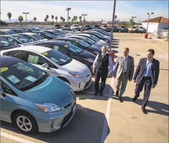  ?? Gina Ferazzi Photograph­s by Los Angeles Times ?? ROGER HOGAN JR., left, Roger Hogan and Stephen Hogan at Toyota of Claremont in January 2018. The dealership sued Toyota, alleging that recalls for Prius’ electric power system didn’t fix the defects.