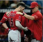  ?? CHRIS O'MEARA – THE ASSOCIATED PRESS ?? Angels manager Phil Nevin and Randal Grichuk look at Grichuk's helmet after he was hit in the head by a pitch from Tampa Bay's Shawn Armstrong on Tuesday.