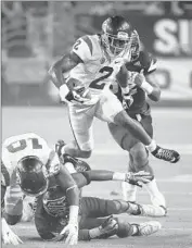  ?? Norm Hall
Getty Images ?? ADOREE’ JACKSON hurdles a defender. He had an 80-yard catch and run for a score in the first quarter.