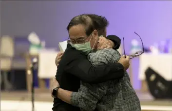  ?? Jae C. Hong/Associated Press ?? Jason Aguilar, left, a senior pastor at Arise Church, comforts Billy Chang, a 67-year-old Taiwanese pastor who survived Sunday’s shooting at Geneva Presbyteri­an Church, during a prayer vigil Monday in Irvine, Calif.