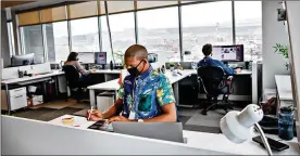  ?? THE NEW YORK TIMES ?? Employees with Vivint work at their office in Lehi, Utah. The company is allowing 40% of its employees to return, though only about 20% have chosen to do so.