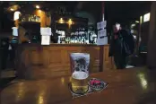  ?? JON SUPER — THE ASSOCIATED PRESS ?? A view of a beer glass at the Dispensary pub in Liverpool, England, is seen Monday. The British government has carved England into three tiers of risk in a bid to slow the spread of a resurgent coronaviru­s.