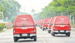  ??  ?? Thailand Post’s delivery vans and trucks leave the head office on Chaeng Watthana Road.