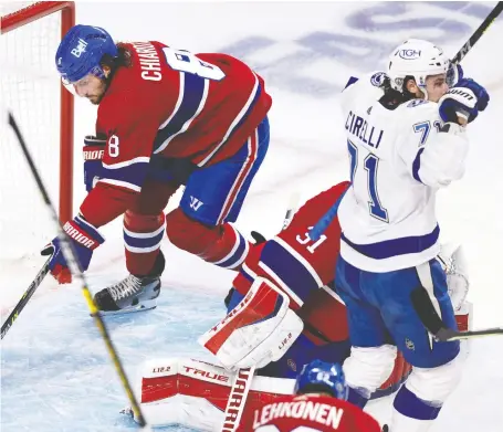  ?? ALLEN MCINNIS ?? Canadiens defenceman Ben Chiarot can't get behind goaltender Carey Price in time to prevent a Tampa Bay goal during Game 3 of the Stanley Cup Final on Friday night at the Bell Centre in Montreal. The Lightning won the game 6-3 to take a 3-0 strangleho­ld on the series.
