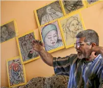  ?? AP ?? Iraqi painter Mustafa Al Taee sits in front of a display of his art work at his home in the northern town of Hamam Al Alil, near Mosul. —