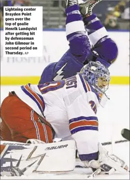  ?? AP ?? Lightning center Brayden Point goes over the top of goalie Henrik Lundqvist after getting hit by defenseman John Gilmour in second period on Thursday.