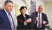  ?? Reuters ?? Palestinia­n Ambassador to Lebanon Ashraf Dabbour (left) with Rima Khalaf (centre) as she holds a gift, an Arabic calligraph­y that reads ‘All the world is Palestine’, after announcing her resignatio­n from the UN in Beirut on Friday.