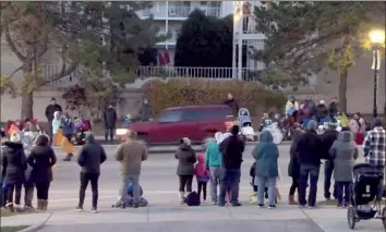  ?? The City of Waukesha via The New York Times ?? A provided image shows a car along a parade route in Waukesha, Wis., that later plowed into a crowd. A witness said the vehicle sped down the street as the parade was going on.