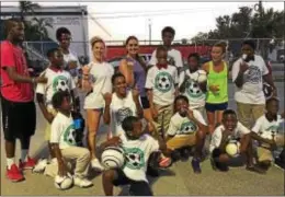  ?? COURTESY OF COLLEEN WILLIAMS ?? The SistaSocce­r program helps out youngsters in need of soccer gear. Here founder Colleen Williams, vice president Julie Oberholtze­r and business developmen­t director Alysha Mallon hang out with a group from Miami.