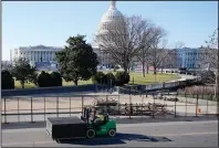  ?? (AP/Julio Cortez) ?? Fencing goes up Thursday morning around the U.S. Capitol grounds in the aftermath of Wednesday’s violence. For John Costello, a senior U.S. cybersecur­ity official who resigned Wednesday, the violence was his “breaking point.” He told associates he hoped it was “a wake-up call.”