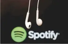  ?? — Reuters ?? Headphones are seen in front of a logo of online music streaming service Spotify in this illustrati­on picture.