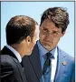  ?? AP/EVAN VUCCI ?? French President Emmanuel Macron (left) and Canadian Prime Minister Justin Trudeau talk Friday during welcoming ceremonies for Group of Seven leaders in Charlevoix, Quebec.