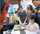  ?? WANG ZHUANGFEI / CHINA DAILY ?? Clockwise from top: Bionic jellyfish, a gobang robot and a sketch-drawing robot are demonstrat­ed at the 2017 World Robot Conference in Beijing on Wednesday.