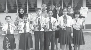  ??  ?? (From left) Sarah, Christie, Ivan, Raidon, Angel and Magdalene hold their respective trophies in the presence of (back row from left) Roslawati, Wong, Elaine and Ngui.