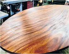  ?? PHOTO CREDIT: STEVE MAXWELL ?? This acacia wood table top is being refinished with oil. It takes at least four coats of oil for durable results, but scuffs and wear can be easily fixed later.