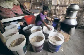  ?? ?? YOUNG MAN PREPARES LIQUOR in Sekmai; a 2012 photograph.