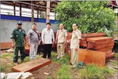  ?? SUPPLIED ?? Officials pose for a photograph yesterday after seizing illegal timber in Ratanakkir­i province.