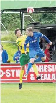  ??  ?? Danny Mitchley in an aerial challenge for