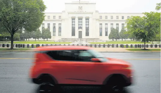  ?? AP ?? In this May 22, 2020 photo, a car drives past the Federal Reserve building in Washington.