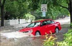  ?? SUBMITTED PHOTO ?? A car is swept away by flood waters on Midland Avenue in Radnor following torrential donwpours on Monday.