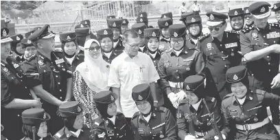  ?? — Gambar Bernama ?? ERAT SILATURAHI­M: Adnan (tengah) beramah mesra dengan sebahagian anggota polis semasa hadir pada Majlis Ramah Mesra Bersama Warga PDRM Negeri Pahang di Kompleks Logistik dan Perumahan PDRM Alor Akar, di Kuantan semalam.