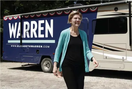  ?? AP ?? OVERREACTI­ON RINGLEADER: Democratic presidenti­al candidate Sen. Elizabeth Warren, D-Mass., exits a motor home as she visits a park along the Des Moines River Friday in Humboldt, Iowa. Warren supporters, below, rally Friday in Clear Lake, Iowa.