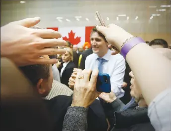  ?? CP PHOTO ?? Supporters reach out to Prime Minister Justin Trudeau after a town hall meeting at the University of Manitoba in Winnipeg.